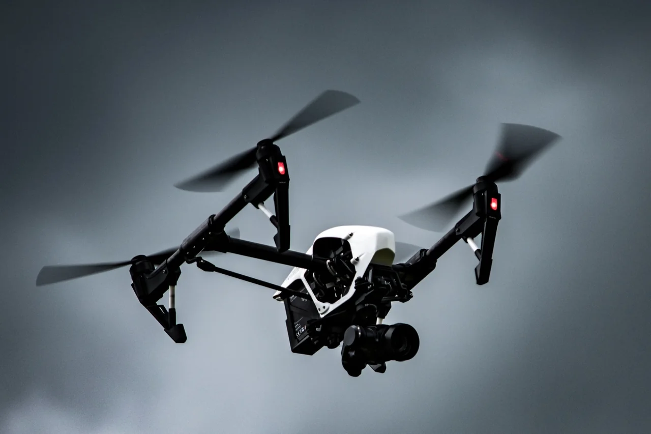 Drone in flight against a cloudy sky